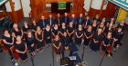 The choir in their uniform, ladies with broches, gentlemen in colourful ties.